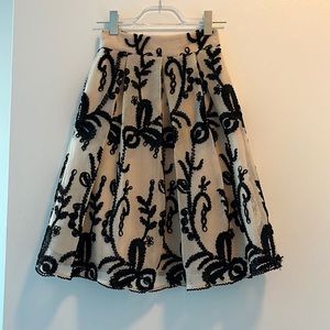 dRA also Angeles via anthropologie cream skater skirt with black textured detail